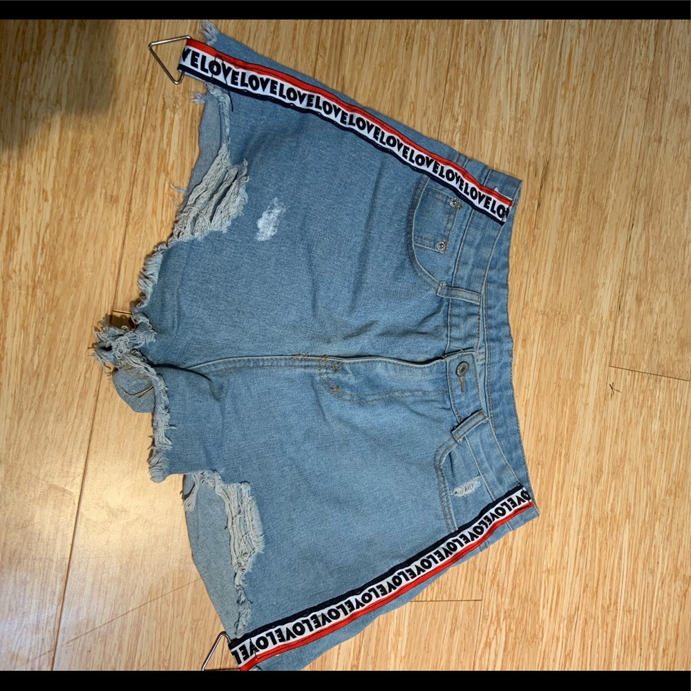 blue denim shorts with “Love” stripes